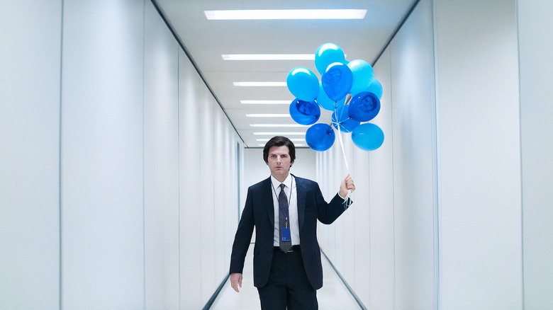 Adam Scott as Mark S. walking down the halls of Lumon with balloons in Severance season 2