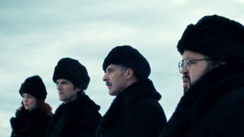 Britt Lower as Helly, Adam Scott as Mark, John Turturro as Irving, and Zach Cherry as Dylan in winter clothing in Severance season 2