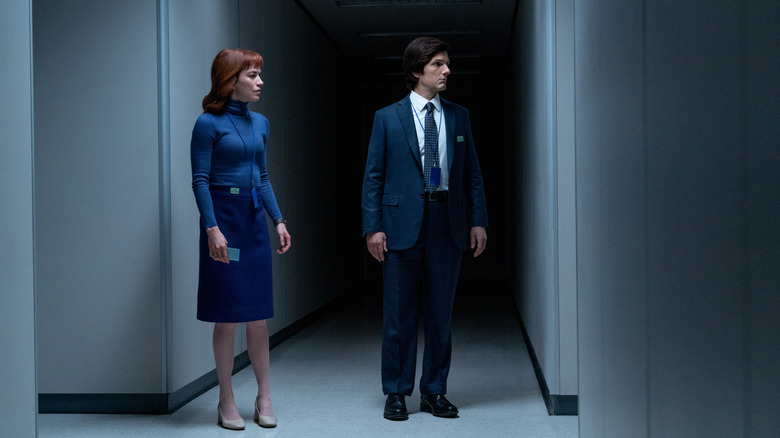 Britt Lower as Helly R. and Adam Scott as Mark S. in a darkened hallway in Severance season 2