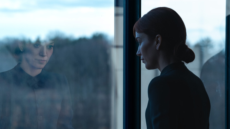 Britt Lower as Helena Eagan looking through a window at Lumon in Severance