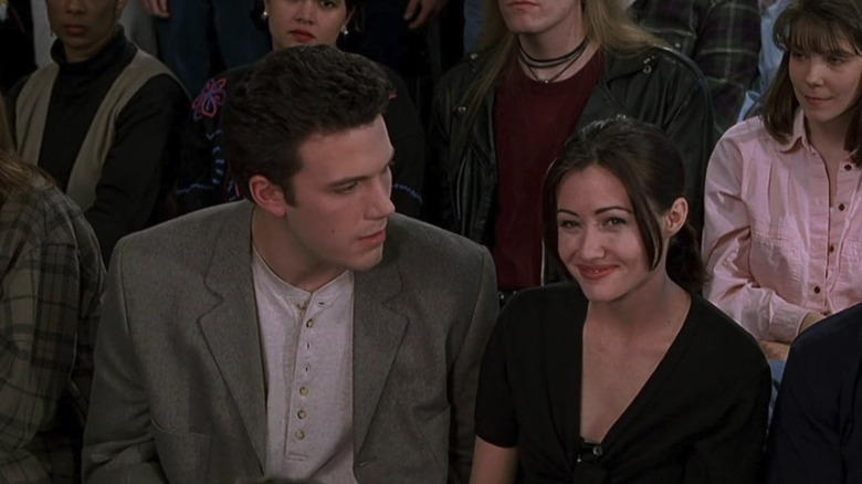 Rene sitting next to Shannon in the audience of a game show in Mallrats