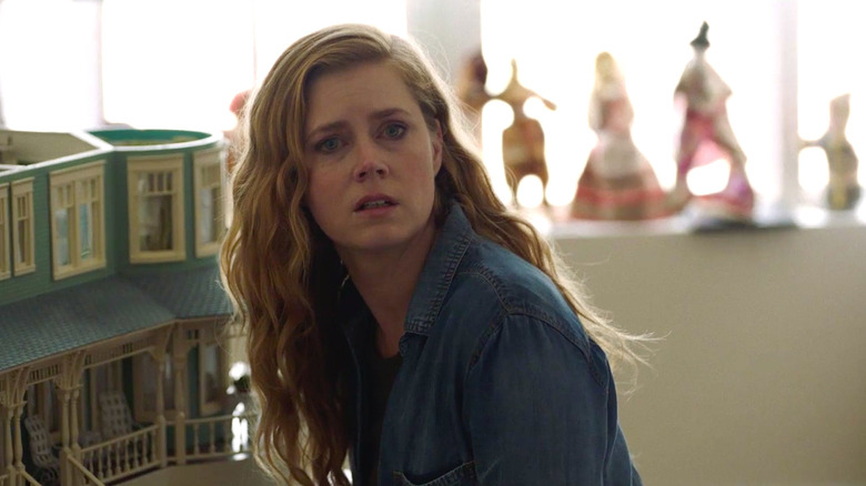 Camille looking horrified near the dollhouse in Sharp Objects