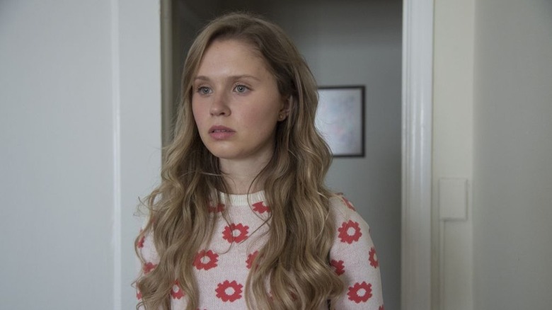 Amma looking surprised in her bedroom doorway in Sharp Objects