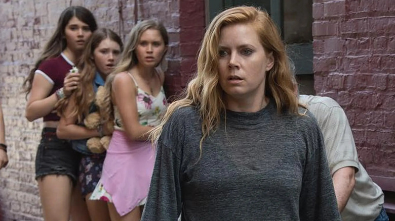 Kelsey, Jodes, and Amma behind a shocked-looking Camille in Sharp Objects