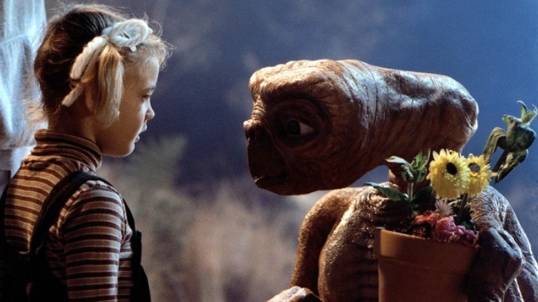Gertie, ET holds flower pot