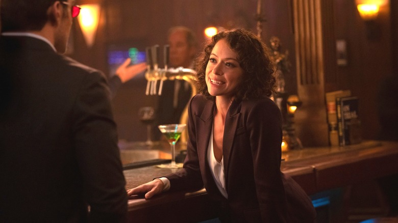 Tatiana Maslany as Jennifer Walters seated at a bar as she's approached by Charlie Cox as Matt Murdock in She-Hulk: Attorney At Law