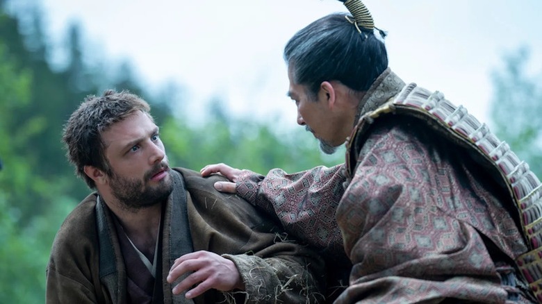 Hiroyuki Sanada as Lord Yoshii Toranaga tends to Cosmo Jarvis as John Blackthorne in Shogun