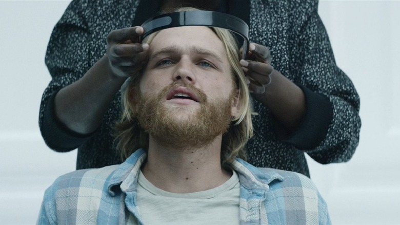 Cooper tries on a headset in Black Mirror