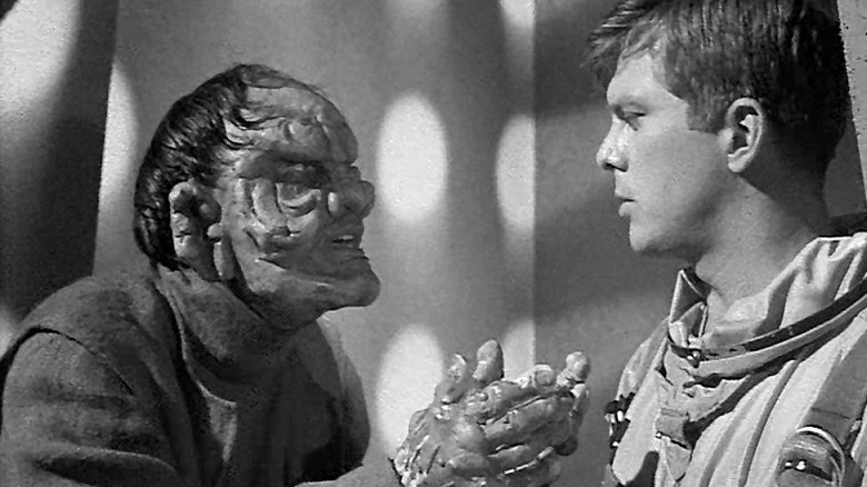An alien confronts an astronaut