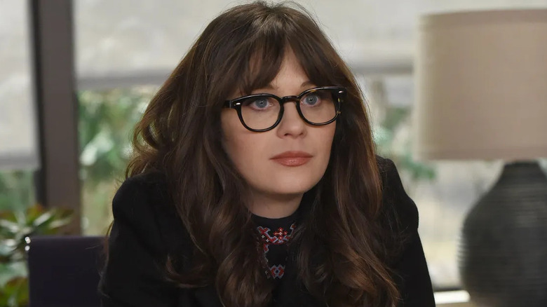 Jess Day (Zooey Deschanel) sits expectantly by a window in New Girl