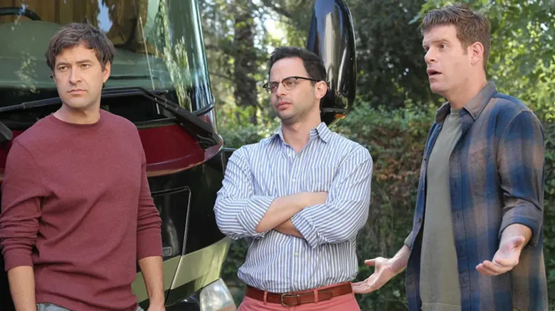Pete Eckhart (Mark Duplass), Rodney Ruxin (Nick Kroll), and Kevin MacArthur (Stephen Rannazzisi) stand incredulously by a bus in The League