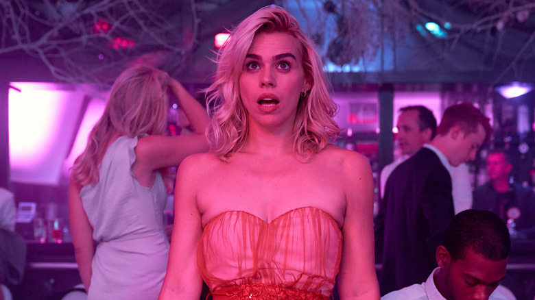 Billie Piper looks off at something in shock