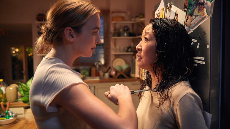 Jodie Comer holds a knife to Sandra Oh's throat