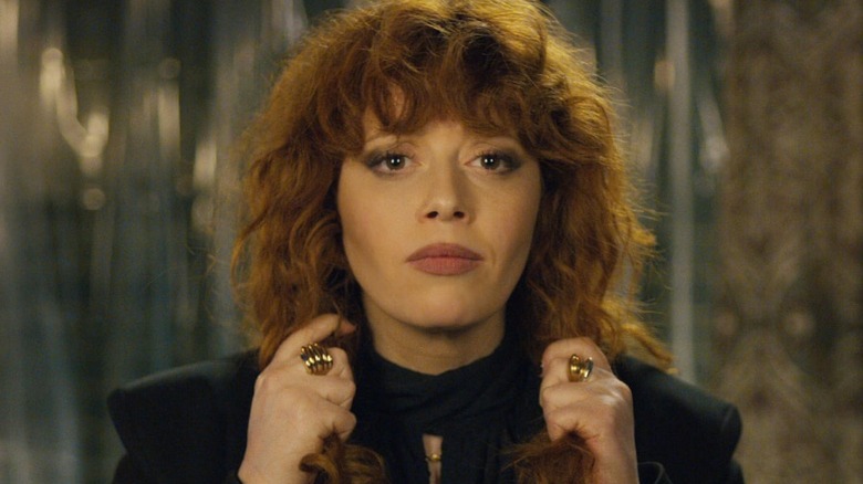 Natasha Lyonne adjusts her hair