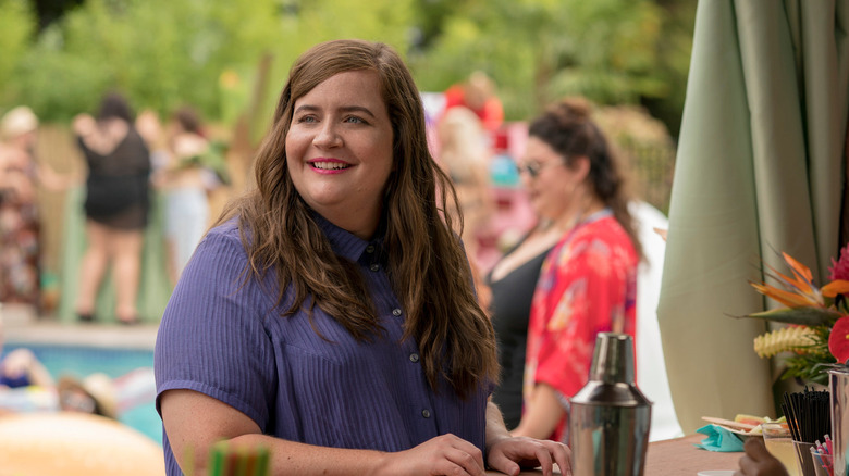 Aidy Bryant smiles, looking off to the side
