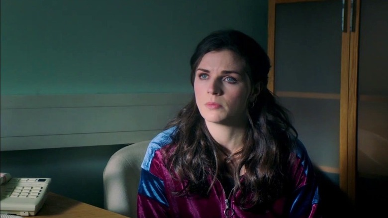 Aisling Bea looks off to the left