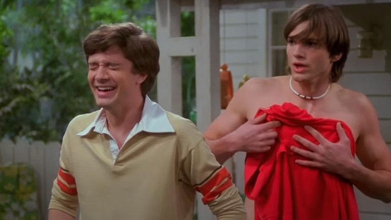 Eric laughs as Kelso is shirtless