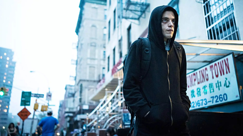 Rami Malek as Elliot Alderson walking alone