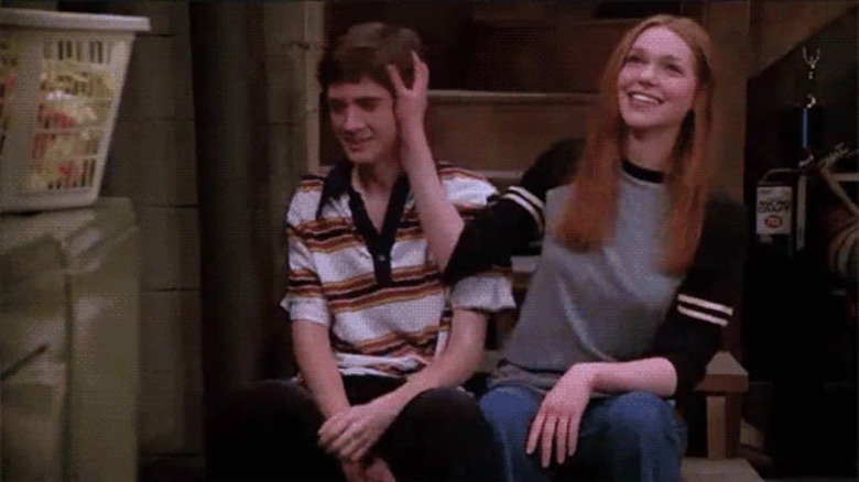 Eric and Donna flirting in a basement