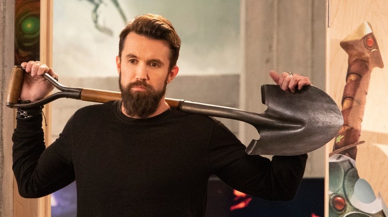 Rob McElhenney holding shovel