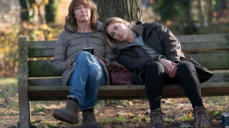 Julianne Nicholson and Kate Winslet sitting on a park bench