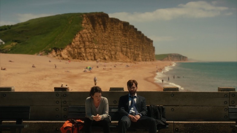 David Tennant and Olivia Colman sit on a bench