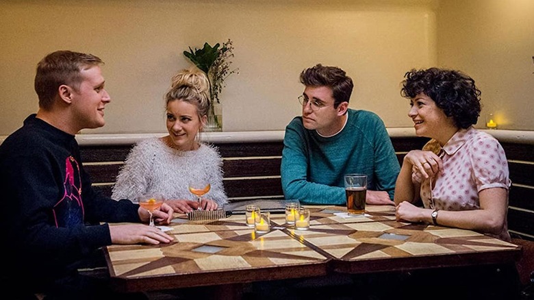 Four young adults meet over drinks