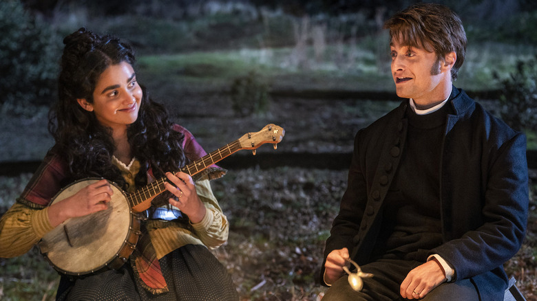 Eliza and Craig sing at a campfire