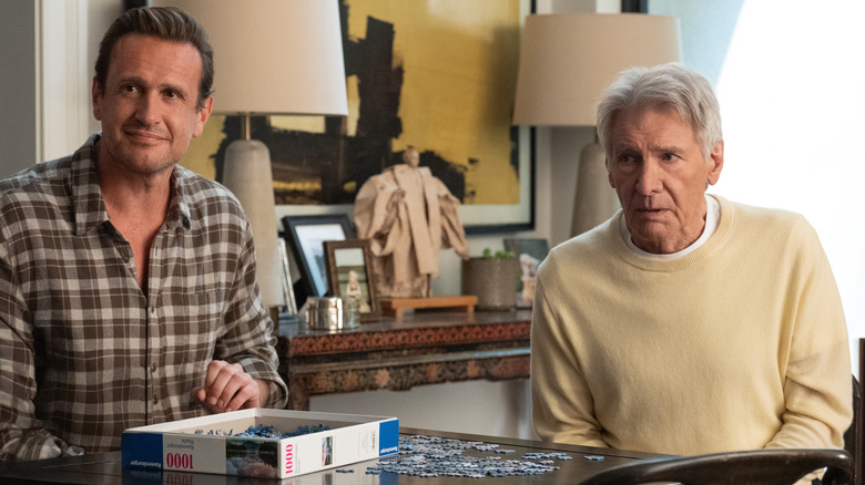 Jason Segel as Jimmy and Harrison Ford as Paul sitting at a table together with a puzzle on Shrinking