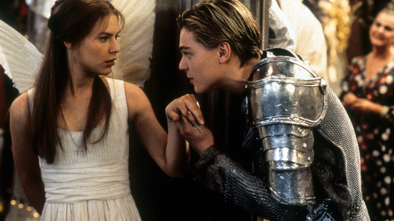 Romeo kisses Juliet's hand at the costume party in Romeo + Juliet (1996)