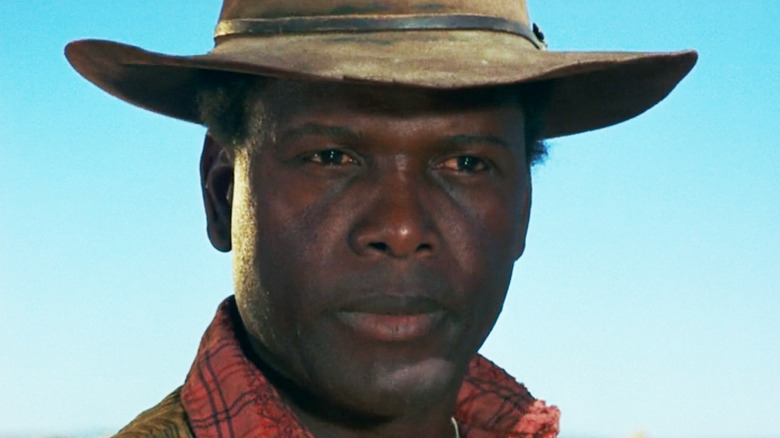 Sidney Poitier's Buck is seen in closeup against a blue sky in Buck and the Preacher