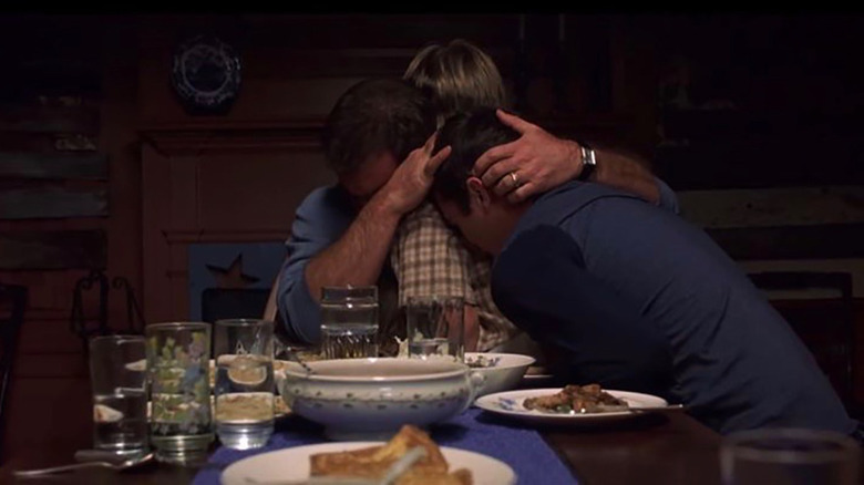 The Hess family hugging in Signs