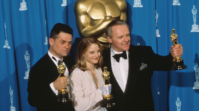 Jonathan Demme, Jodie Foster and Anthony Hopkins holding their Silence of the Lambs Oscars