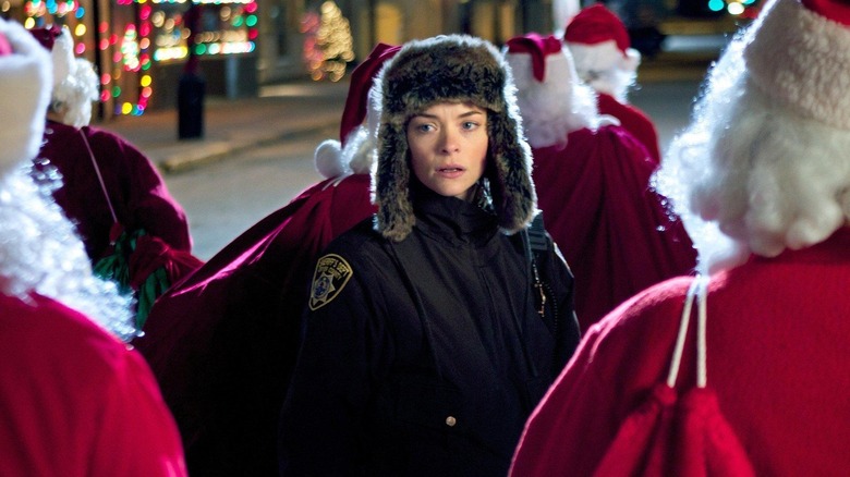Jaime King as Aubrey, surrounded by Santas in Silent Night