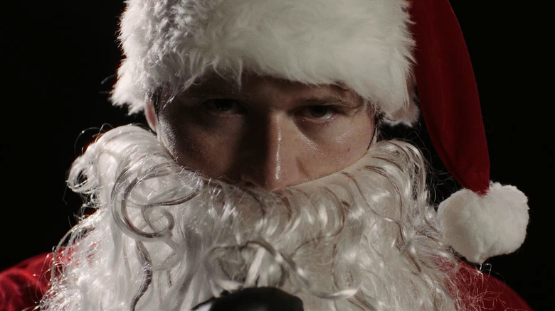 A close up shot of Rohan Campbell as Billy in his santa costume in Silent Night, Deadly Night (2025)