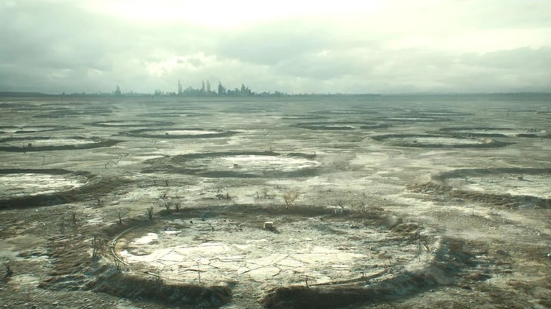 An establishing shot of the devastated surface world with the skyline of Atlanta in the background in Silo