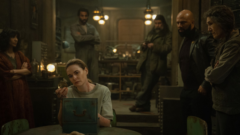 Juliette and her silo pals gather around in Walk's workshop in Silo Season 3