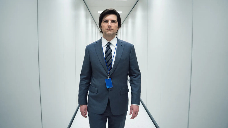 Mark S. walking down a hallway in Severance