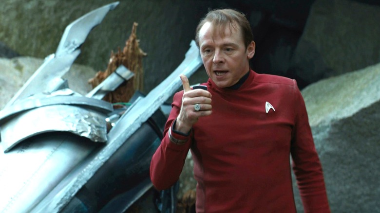 Scotti talks to someone in the Star Treke behind him