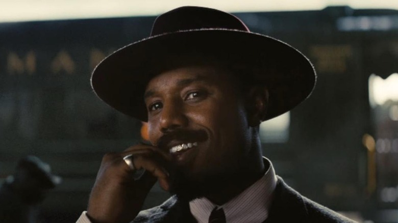 Michael B. Jordan cracks a sly smile as Stack in Sinners