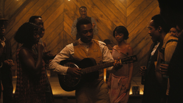 Sammy playing the guitar at the juke joint