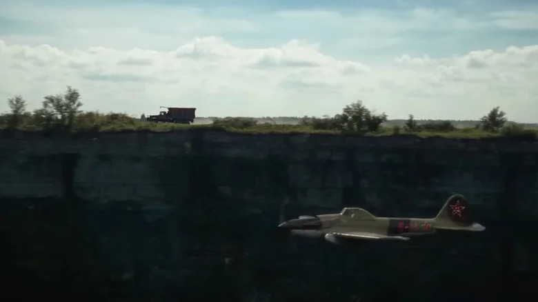 A truck being chased by a plane in Sisu: Road to Revenge