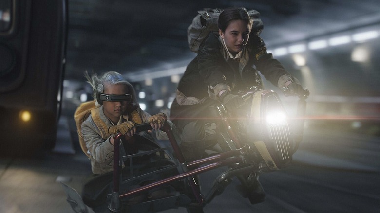 Fern and KB riding a speeder through traffic in Star Wars: Skeleton Crew