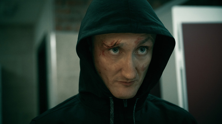 A battered Coe stares at someone off screen in Slow Horses