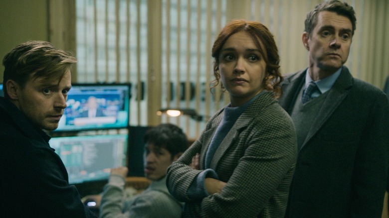 Group at computer looks offscreen