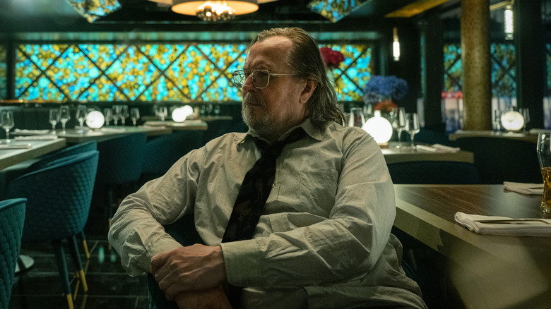 Gary Oldman's Jackson Lamb sits in a restaurant in Slow Horses