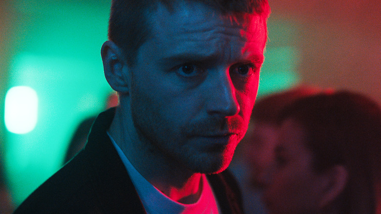 Jack Lowden's River Cartwright is illuminated by neon lights in Slow Horses