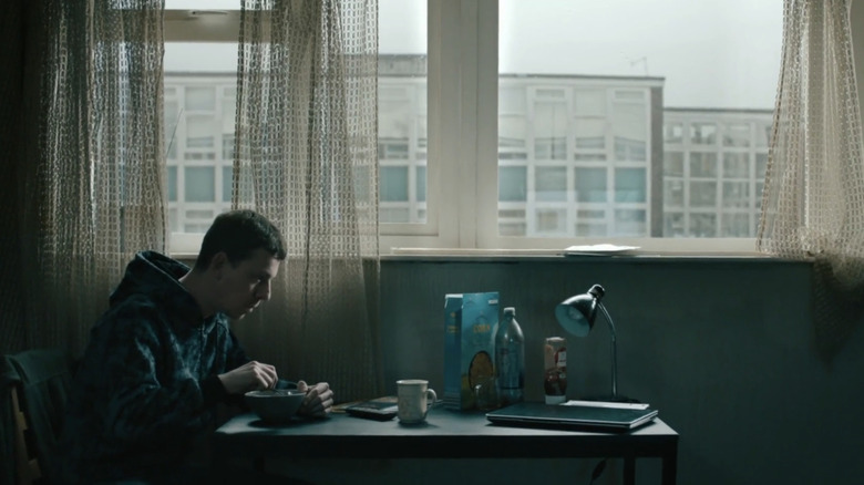 Rob Trew (Edward Davis) sits alone in his apartment in Slow Horses