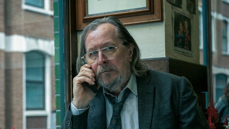 Gary Oldman as Jackson Lamb holding a phone to his ear on Slow Horses