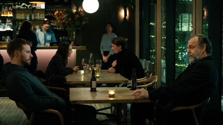 Hugo Weaving's Frank Harkness sits opposite Jack Lowden's River Cartwright in a restaurant in Slow Horses
